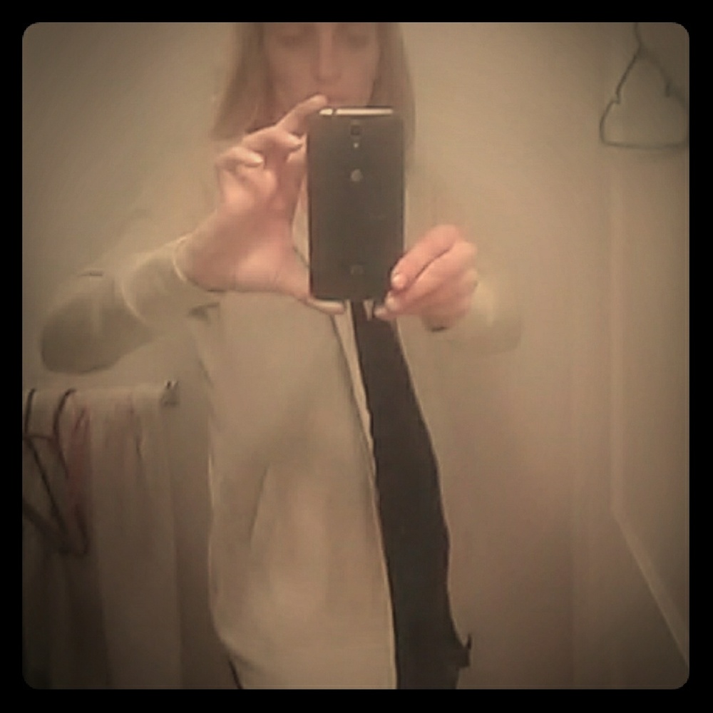 A tan sip up light sweater cover up.